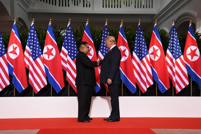 Tensions then smiles as Kim and Trump reach hands across history