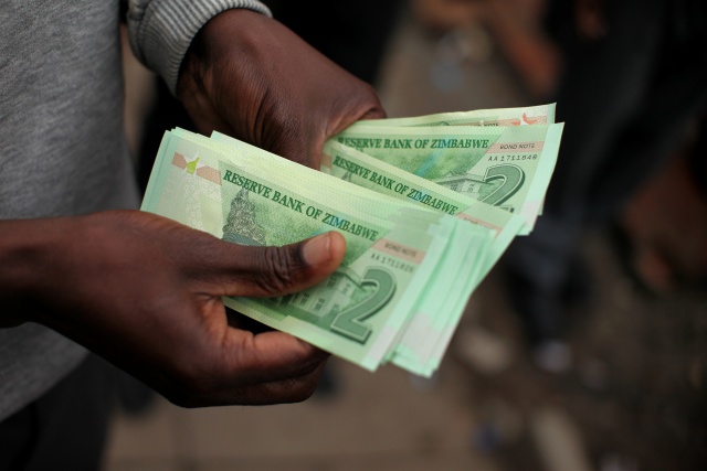 Zimbabwe ends foreign currency use as inflation spirals