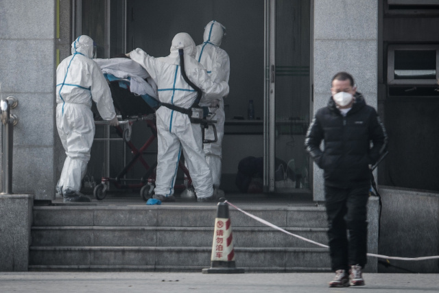 China says virus spreading between humans as WHO set to meet