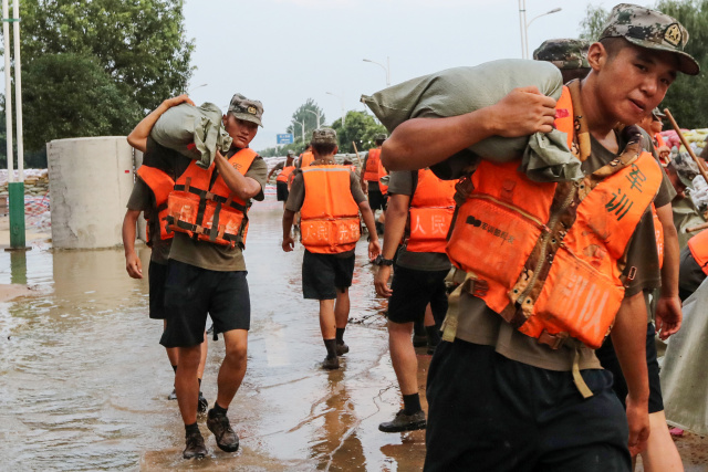 China rushes to contain floods after record rainfall