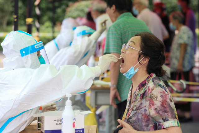 China battles biggest Covid outbreak in months as US ramps up vaccine push