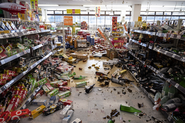 Residents survey damage after powerful Japan quake