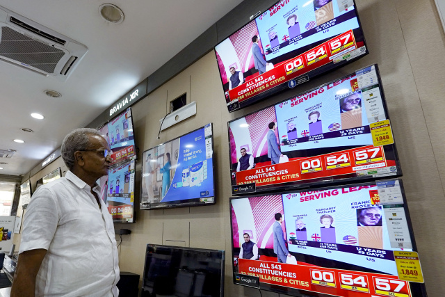 India's Modi eyes election victory, top opponent back behind bars
