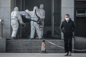 China says virus spreading between humans as WHO set to meet